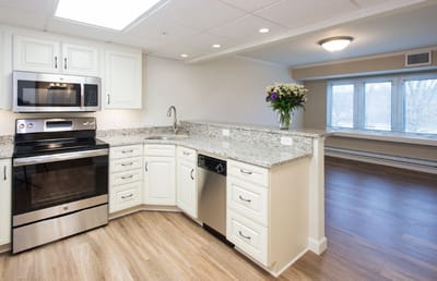 Modern kitchen with stainless steel appliances and granite countertops