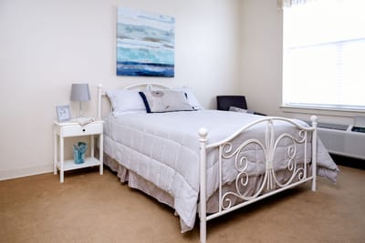 Cozy resident room with a bed and decorative painting