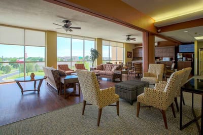 Bright common area with seating and large windows
