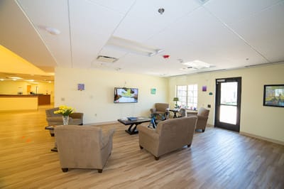 Bright interior common area with seating and TV