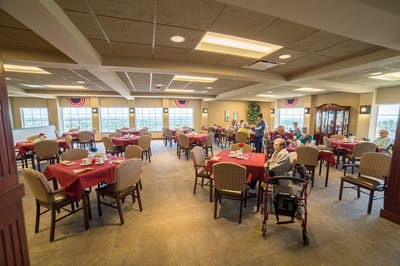 Dining area with tables and residents enjoying meals