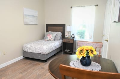 Cozy private bedroom with a dining area