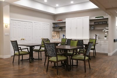 Common area with tables and chairs in a bright space