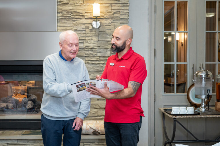 Staff assisting resident with information brochure