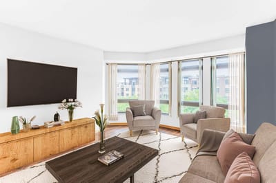 Bright common area with seating and large windows