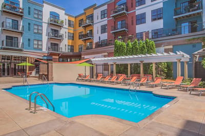 Outdoor pool area with colorful lounge chairs