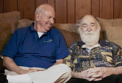 A caregiver and a resident sharing a moment on a couch