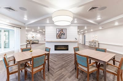 Common area with tables and chairs in a well-lit interior