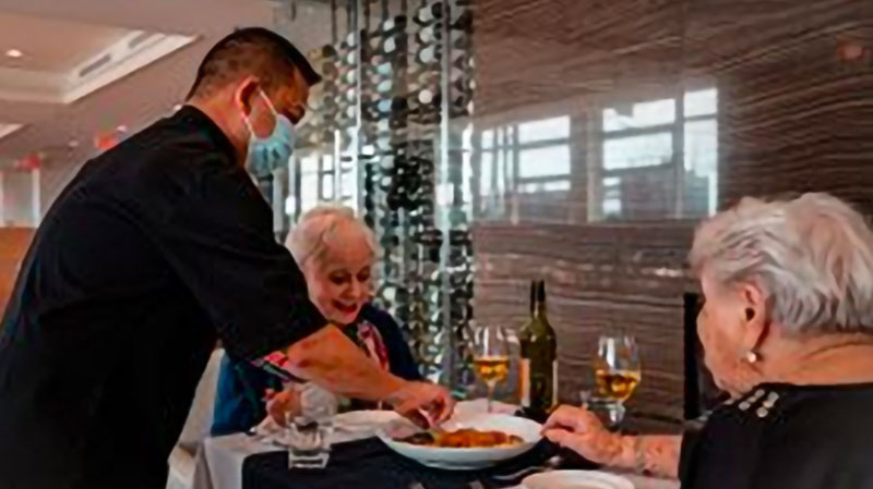 Dining experience with residents and staff in a dining room