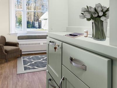 Interior photo of a resident's room with floral arrangement