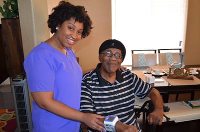 A caregiver assisting a senior resident indoors