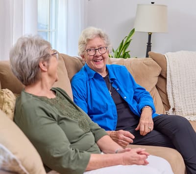 Two residents enjoying a conversation in a common area