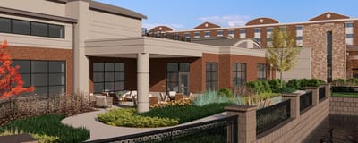 Outdoor view of the facility with seating area and landscaping