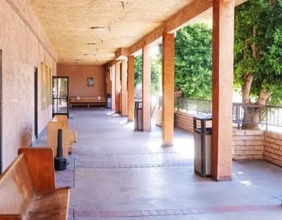 Covered walkway with benches and landscaping