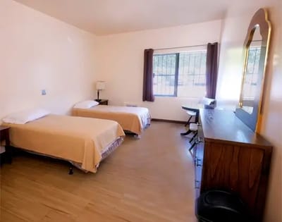 A well-furnished resident room with two beds