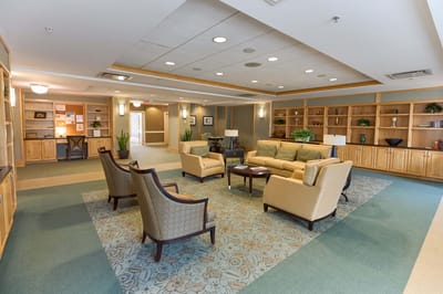 Common area lounge with seating and decorative shelves