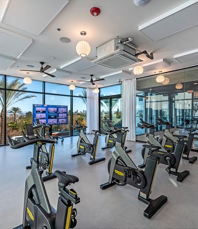 Bright fitness room with exercise bikes and large windows