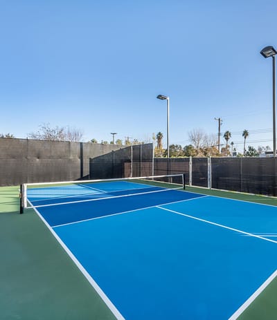 Outdoor tennis court with blue and green surfaces