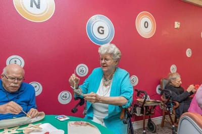 Residents engaged in a bingo craft activity