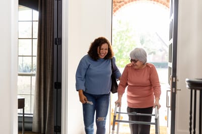 Warm interaction between a resident and staff member in a lobby