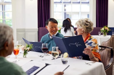Residents enjoying a meal together in the dining room