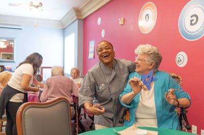 Residents and staff enjoying an activity in a common area