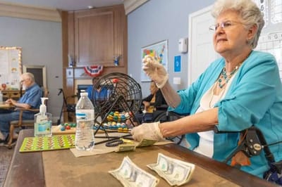 Residents playing bingo in an activity room