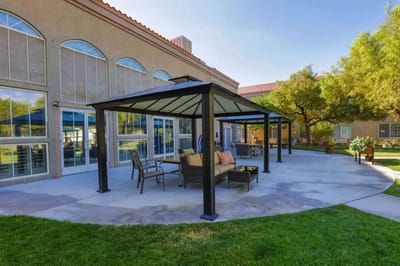 Outdoor seating area with shaded patio and garden