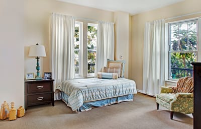 Brightly lit resident room with large windows