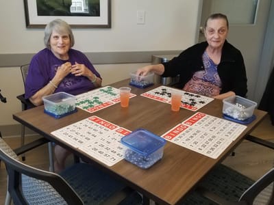 Two residents playing bingo at a table