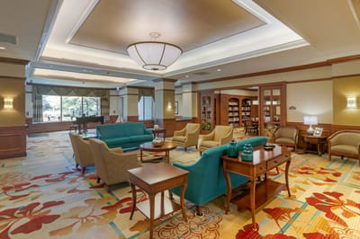 Interior view of a lounge area with seating and bookshelves