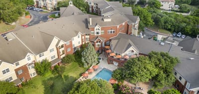 Aerial view of Brookdale Westlake Hills with pool and gardens