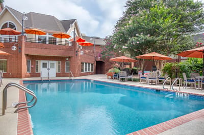 Outdoor pool area with seating and umbrellas