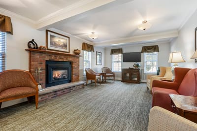 Bright common area with seating and a fireplace