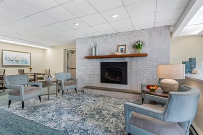 Bright interior lounge area with seating and fireplace