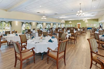 Bright dining room with tables set for residents