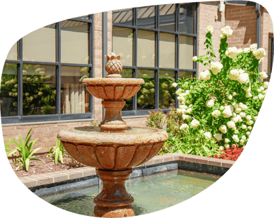 A fountain in a landscaped outdoor area