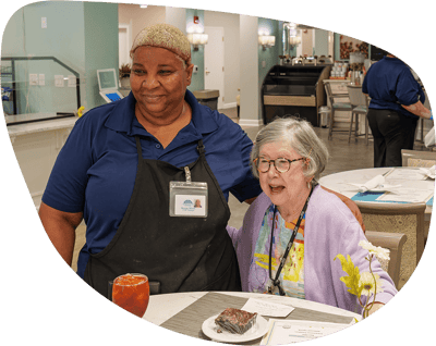 Staff member with resident in a dining area