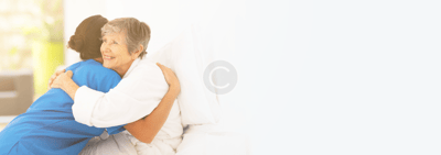 Caregiver embracing a resident in a cozy setting
