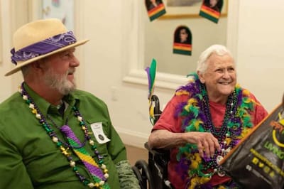 Residents celebrating in a colorful activity room