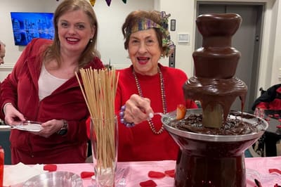 Residents enjoying chocolate fondue at a celebration