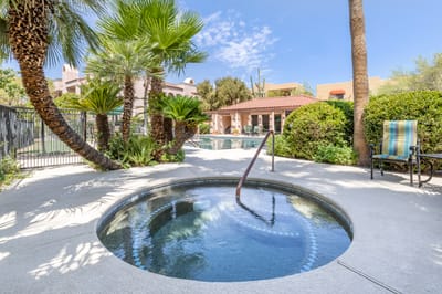 Outdoor pool area with tropical landscaping