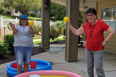 Residents participating in an outdoor activity with balls