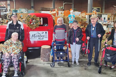 Residents posing together in an indoor market setting