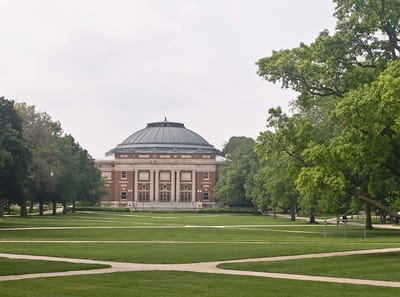 Exterior view of a large building on a green lawn