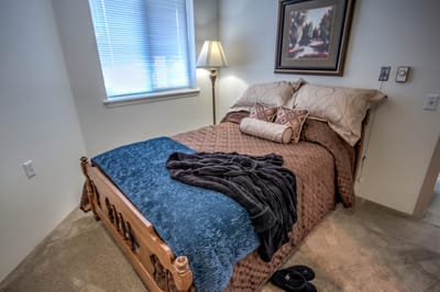 Cozy resident room with bed and lamp