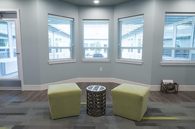 Bright common area with seating and windows