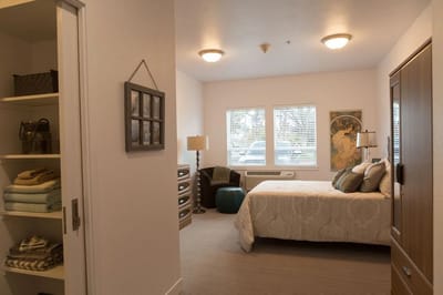 Private resident room with a bed and windows
