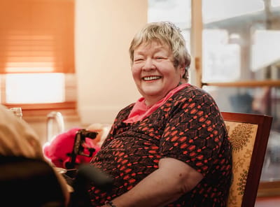 A smiling resident enjoying time in a facility