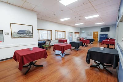 Dining area with tables set for residents